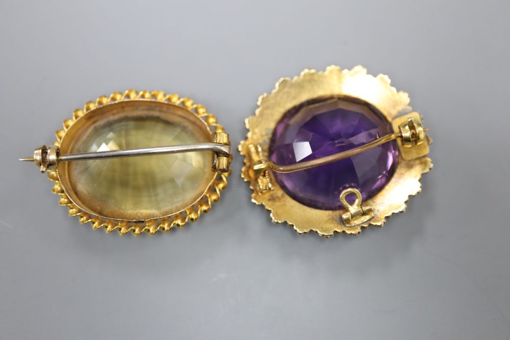 An Edwardian yellow metal, amethyst and split pearl set oval pendant brooch, 30mm and a similar citrine brooch, gross 19.5 grams.